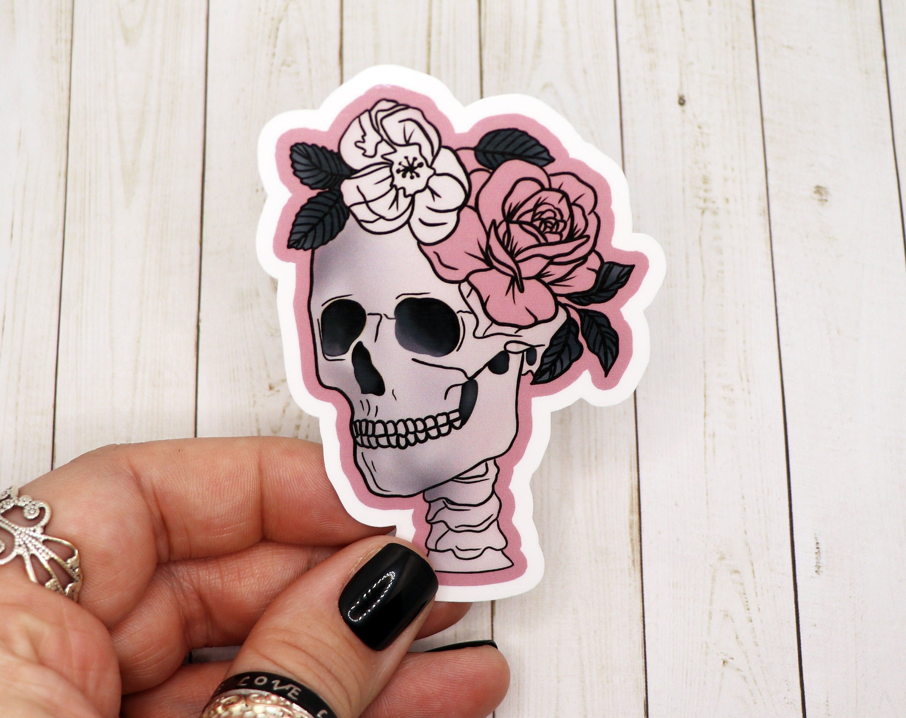 A stylish girly skull sticker featuring a feminine design, perfect for personalizing various items.