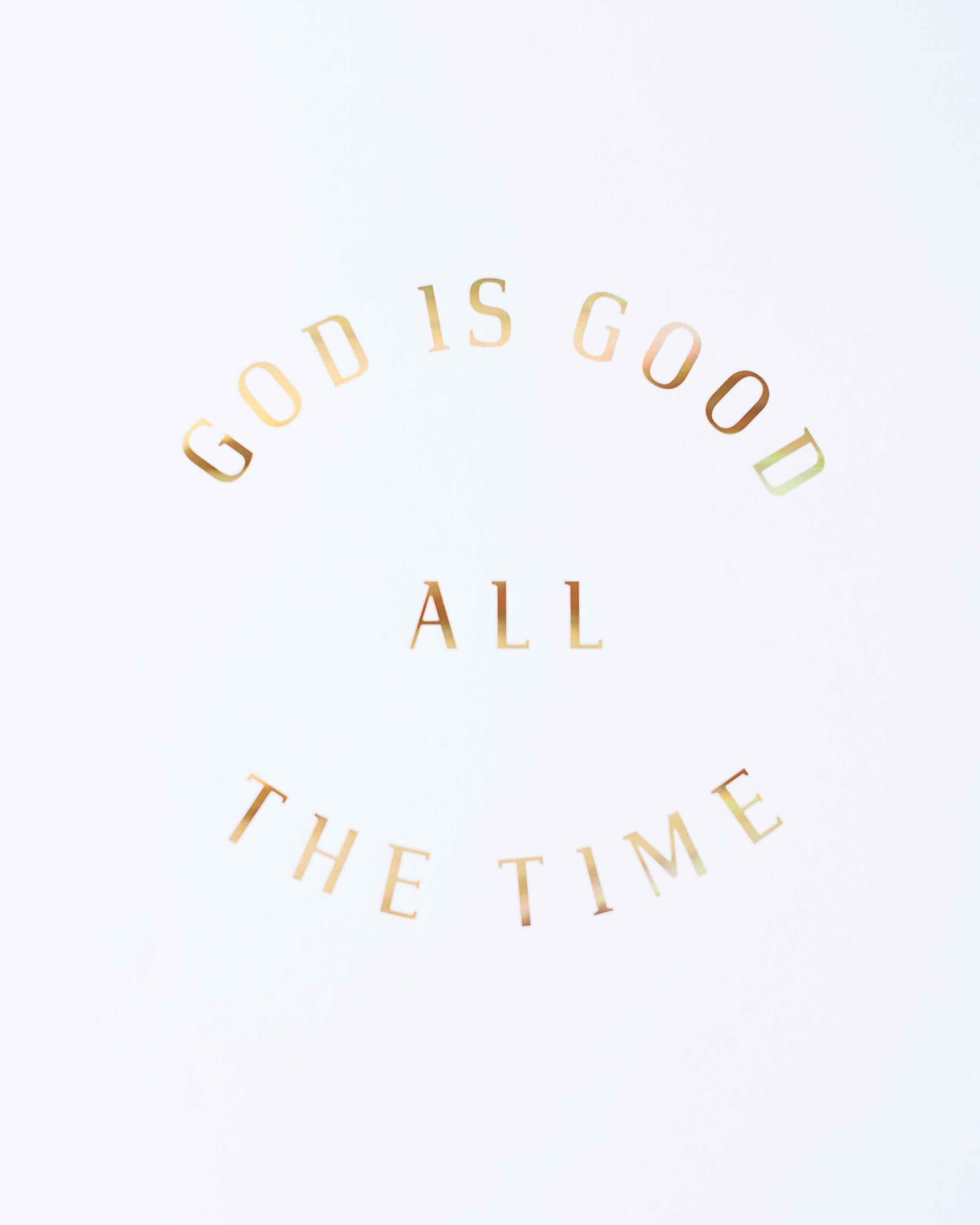 A beautiful print featuring the phrase 'God is Good All The Time' in hologram gold foil on soft ivory stock, perfect for inspiring decor.