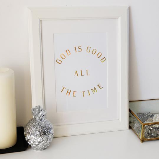 A beautiful print featuring the phrase 'God is Good All The Time' in hologram gold foil on soft ivory stock, perfect for inspiring decor.