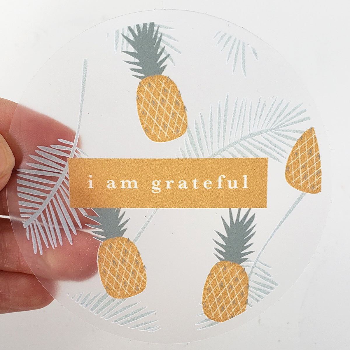 Golden 3-inch clear gratitude sticker with a joyful design, perfect for personalizing items and spreading positivity.