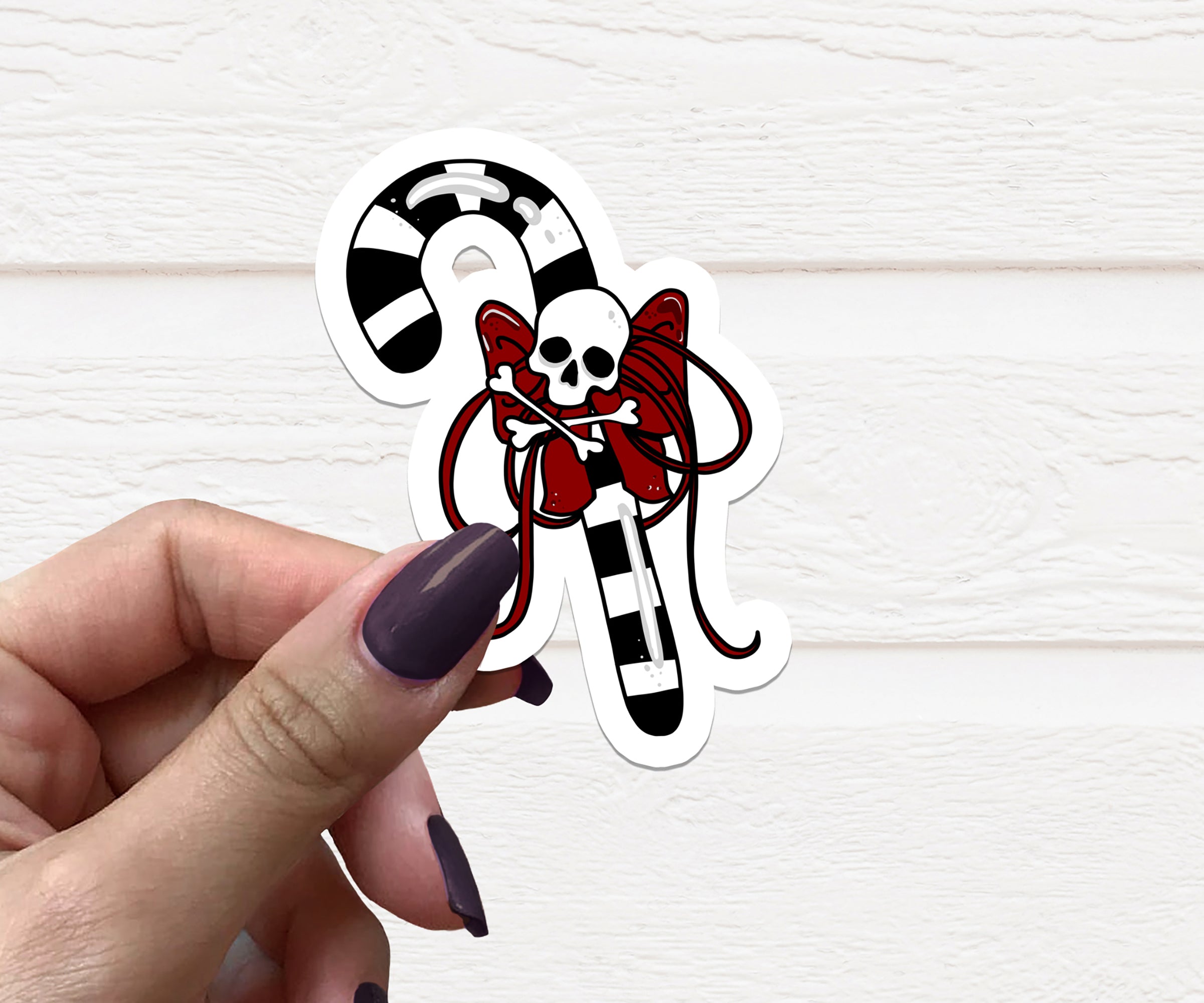 Goth Candy Cane Vinyl Sticker featuring a unique design with a gothic twist, perfect for holiday decorations.