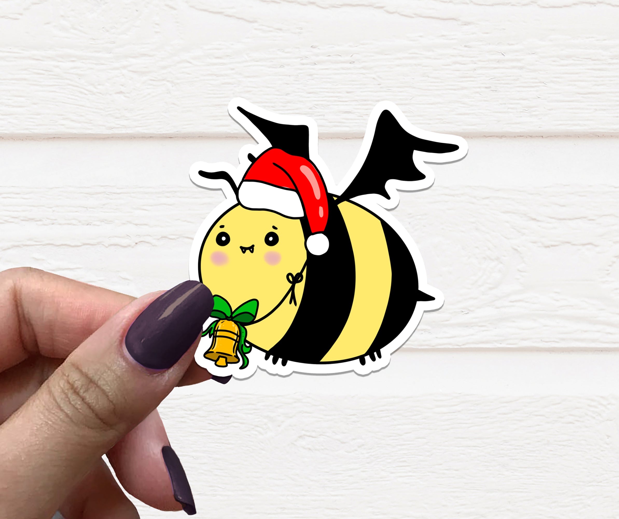 Goth Christmas Bee vinyl sticker featuring a whimsical bee design with gothic elements, perfect for holiday decoration.