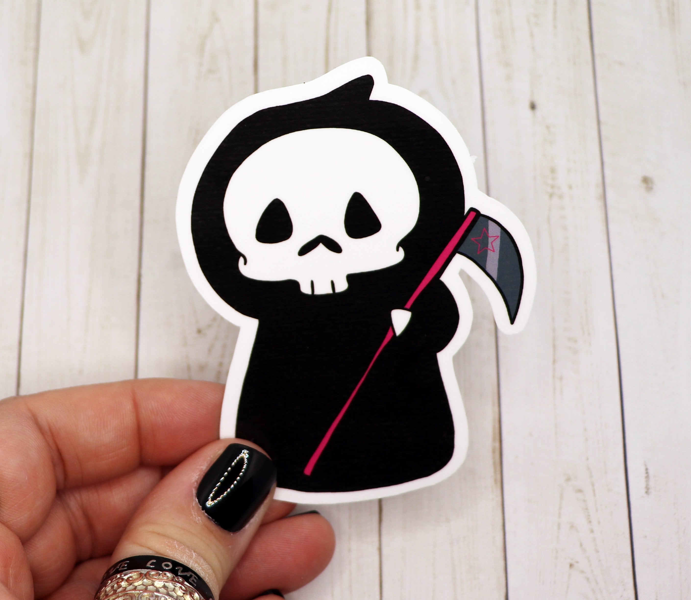 A detailed Grim Reaper Vinyl Sticker featuring a striking design, perfect for personalizing various items.