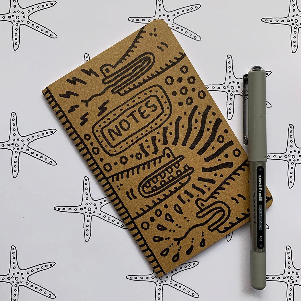 Hand-decorated Moleskine journal featuring reptile designs on front and back covers, signed by the artist.