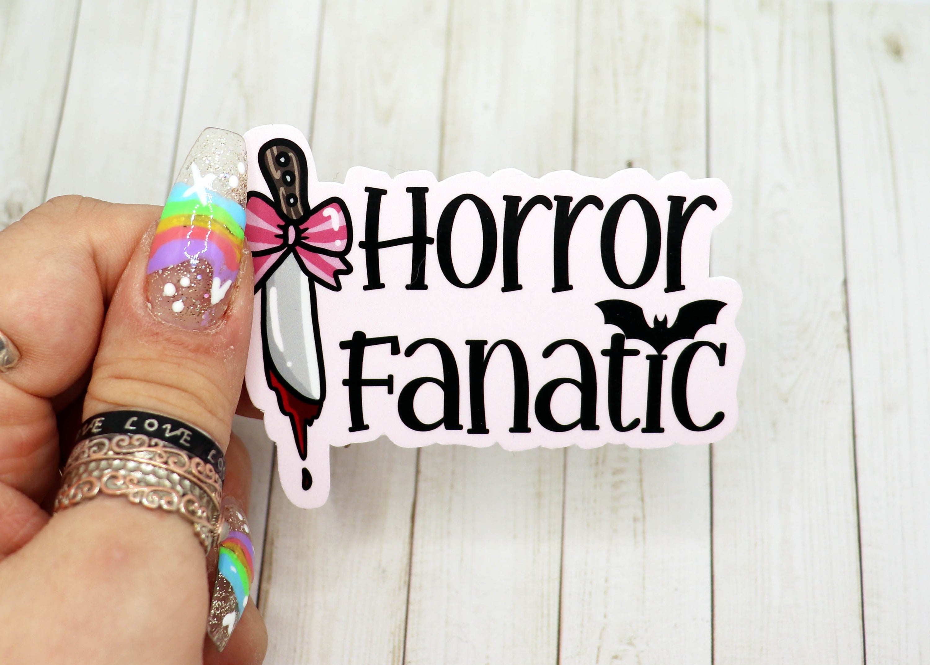 A vibrant Horror Fanatic Vinyl Sticker featuring spooky designs, perfect for personalizing items like laptops and water bottles.