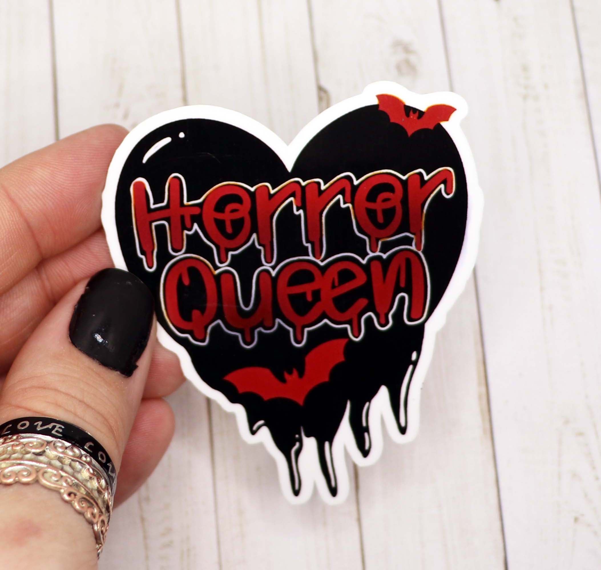 A vibrant 3-inch Horror Queen Heart Sticker featuring a spooky design, perfect for personalizing various items.