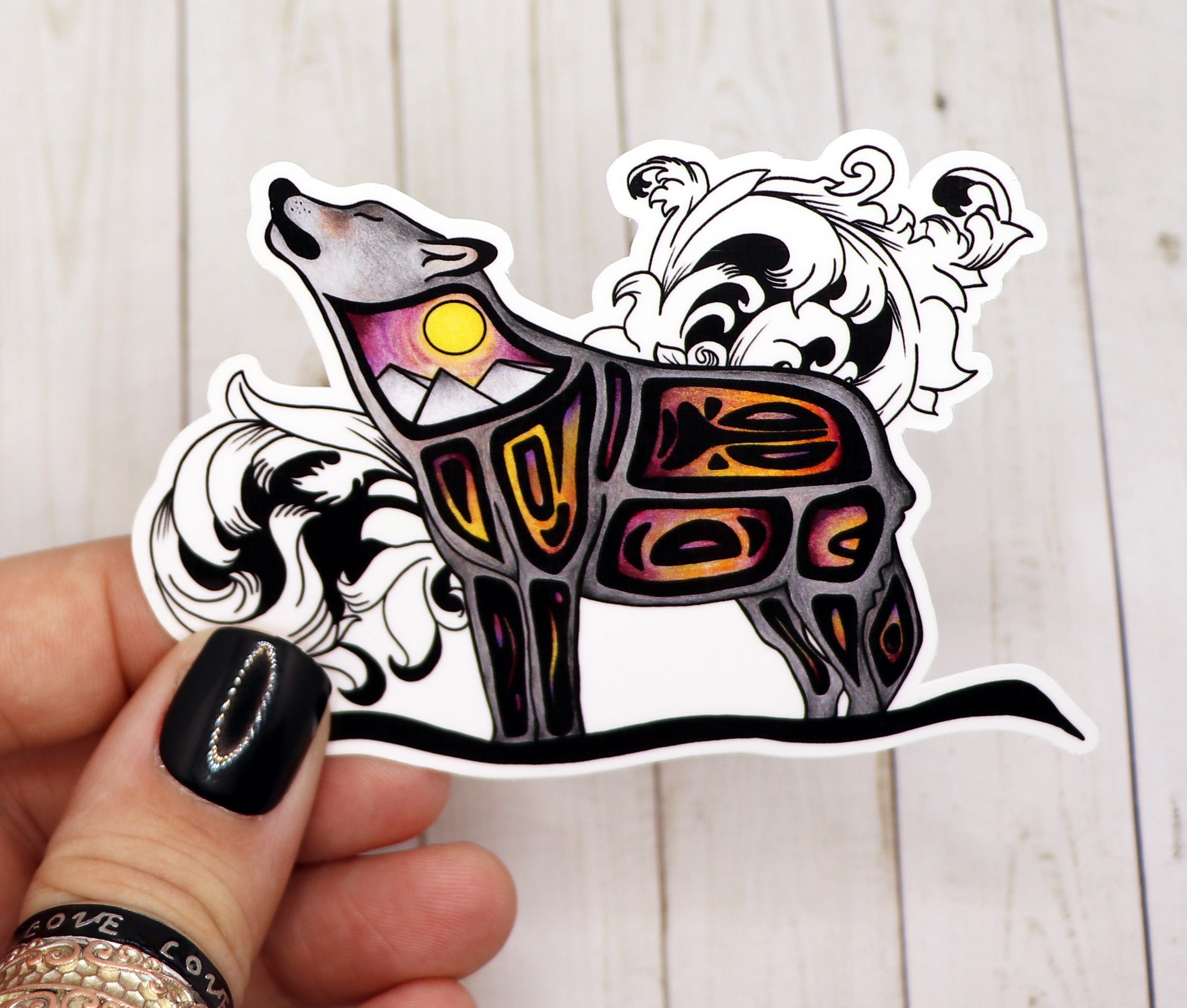 A high-quality matte vinyl sticker featuring a howling wolf design, perfect for personalizing various items.