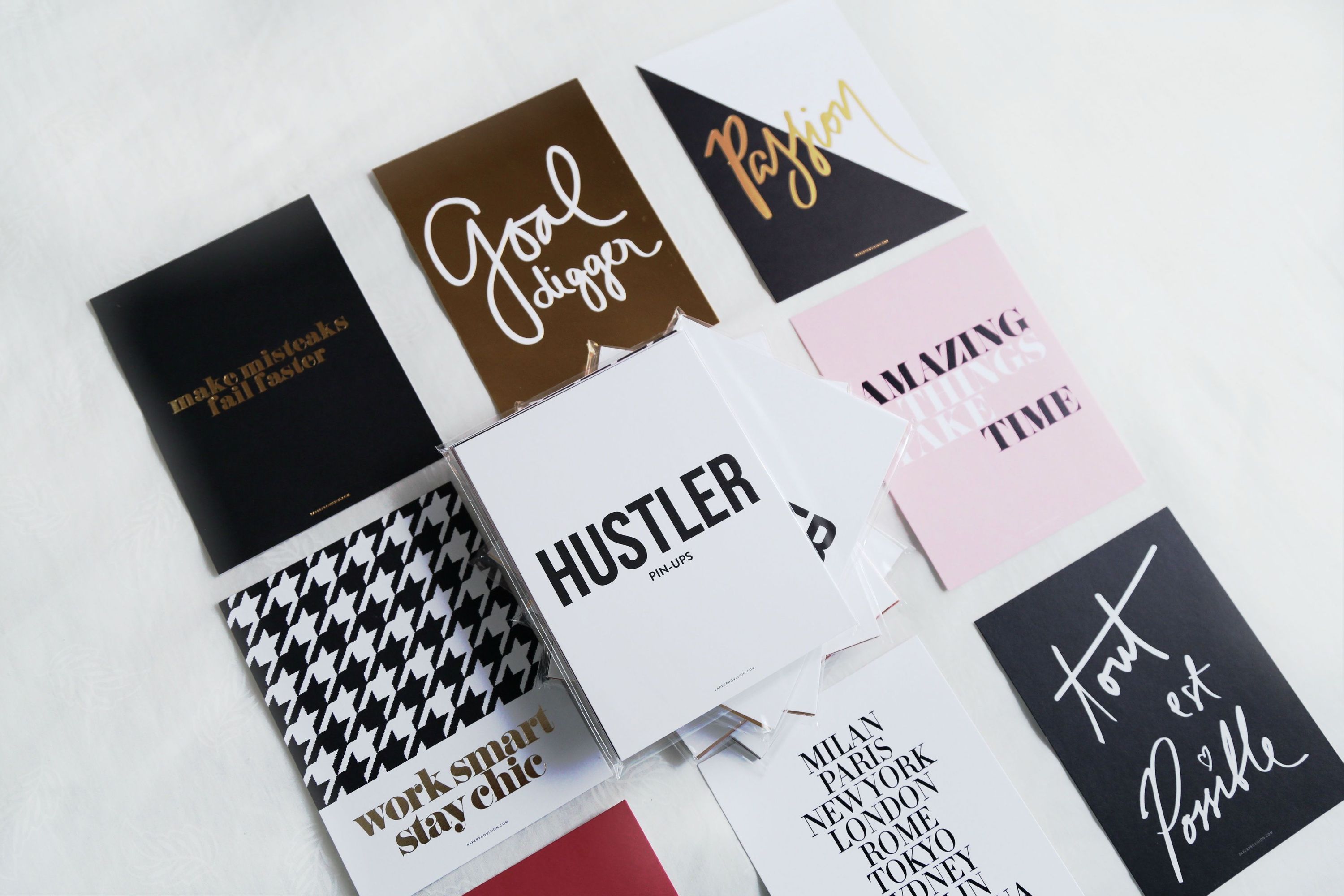 A collection of 9 Hustler Pin-Ups mini prints featuring motivational messages and gold foil accents, perfect for desktop decor.