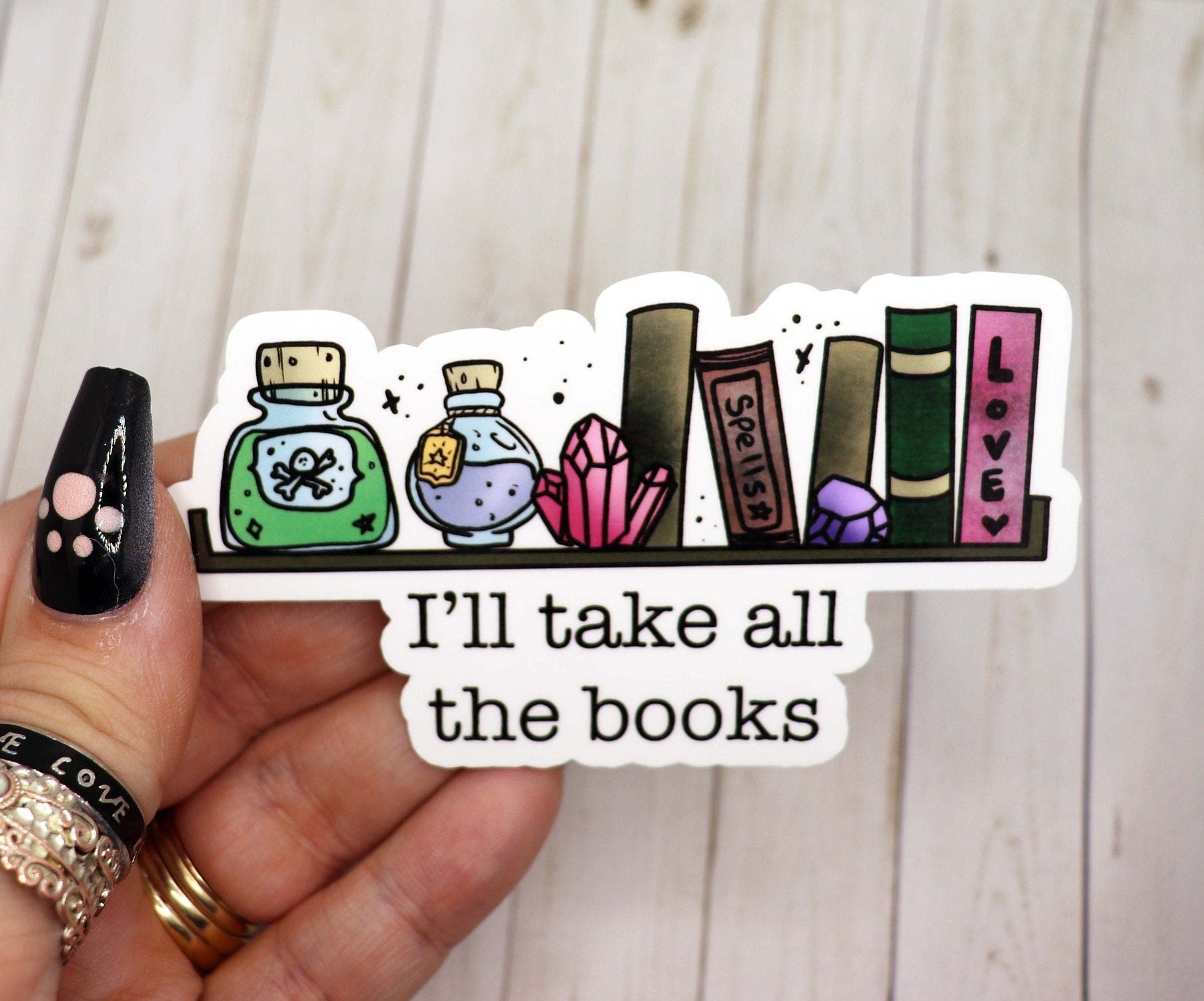 A 3-inch vinyl sticker featuring the phrase 'I'll Take All the Books' in a stylish font, perfect for book lovers.