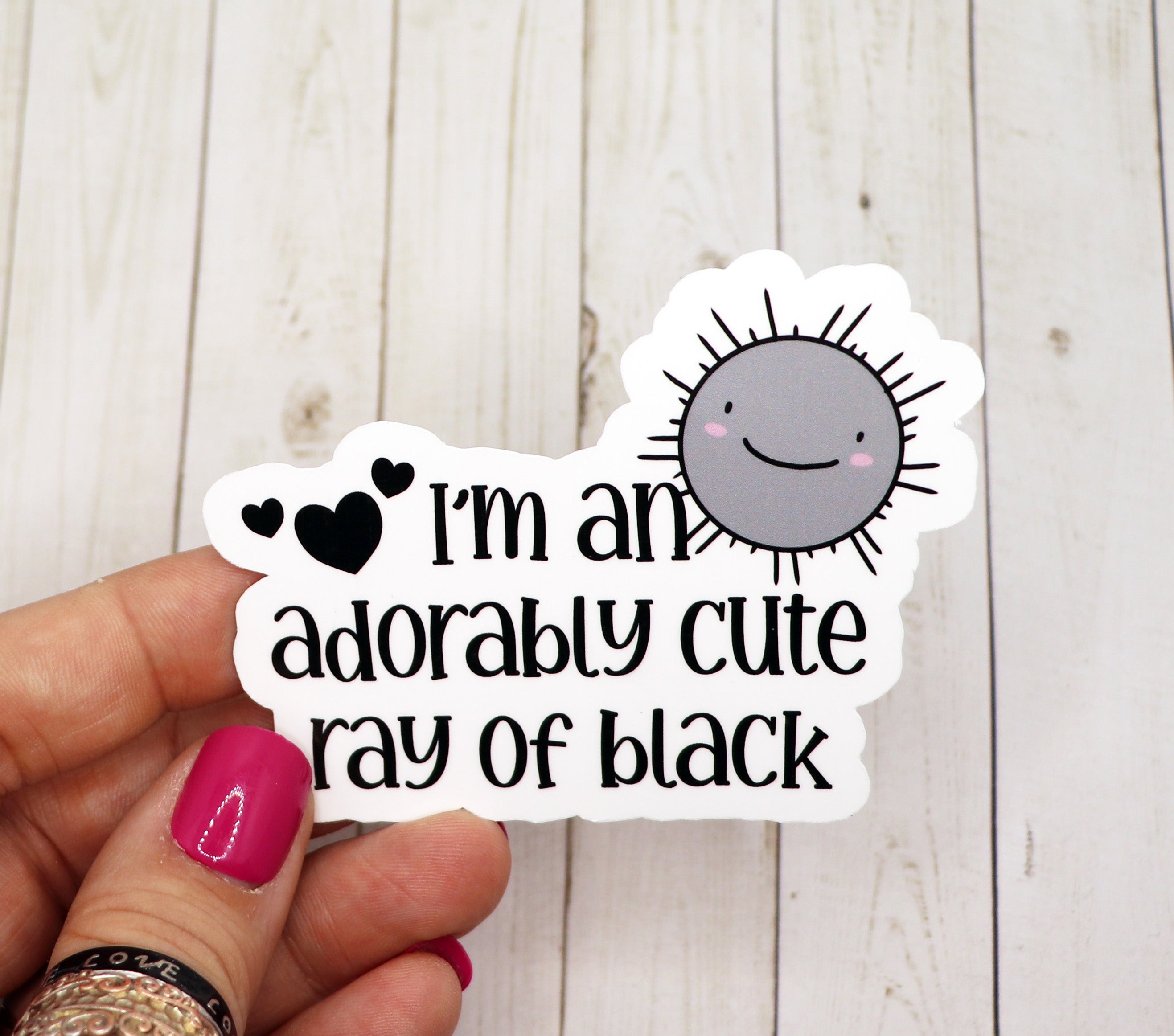 A cute black sticker featuring a ray design, perfect for personalizing items like water bottles and laptops.