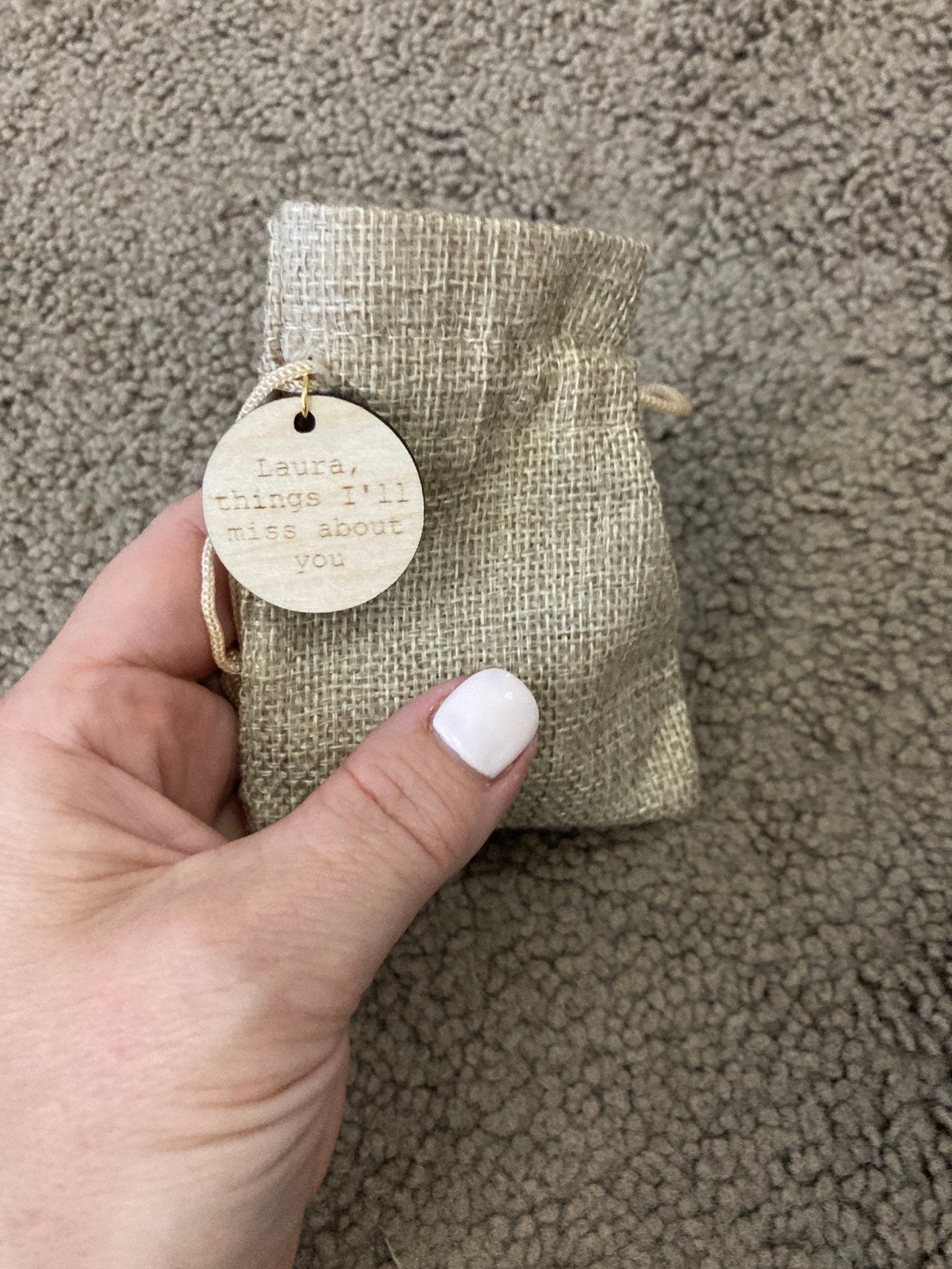 A collection of Inner Calm Coins in a jute bag, showcasing their wooden texture and mindfulness messages.