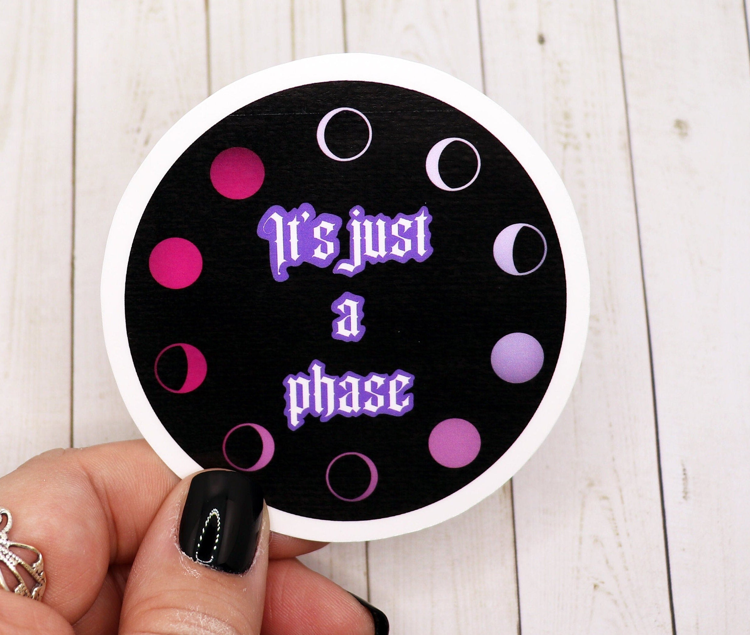 It's Just a Phase vinyl sticker on a white background, showcasing its matte finish and vibrant design.