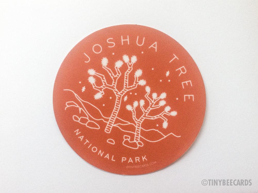 Joshua Tree National Park vinyl sticker featuring an illustration of a Joshua Tree with a rust brown background and text.