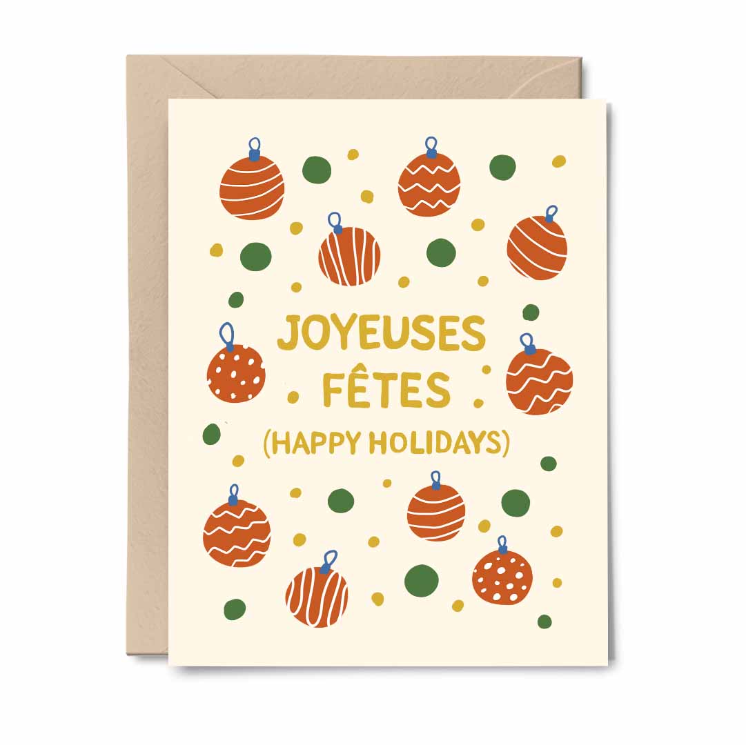 Joyeuses Fêtes greeting card featuring colorful Christmas baubles and ornaments with a kraft envelope.