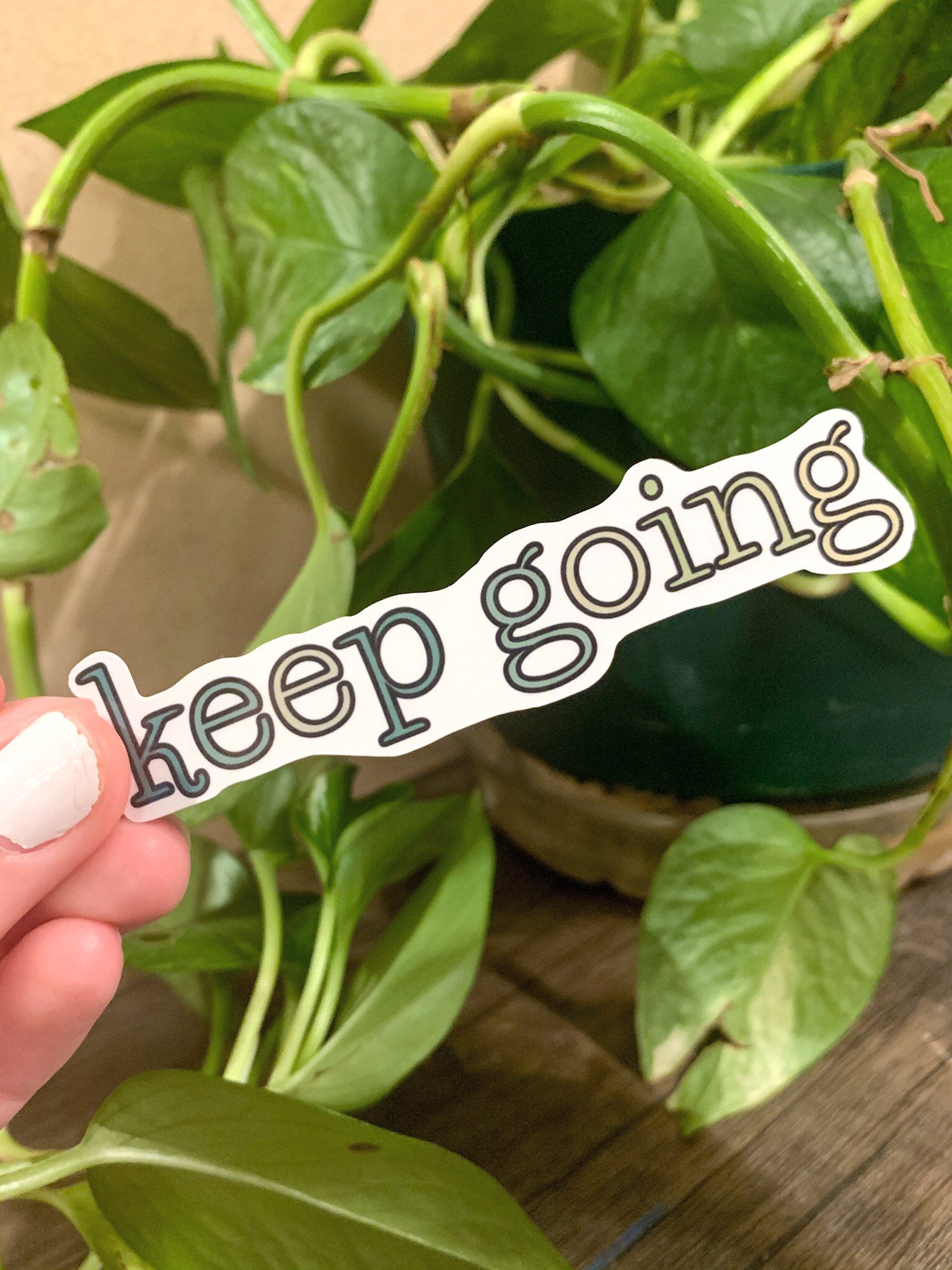 A cute aesthetic Keep Going sticker featuring a motivational design, perfect for personalizing laptops and water bottles.