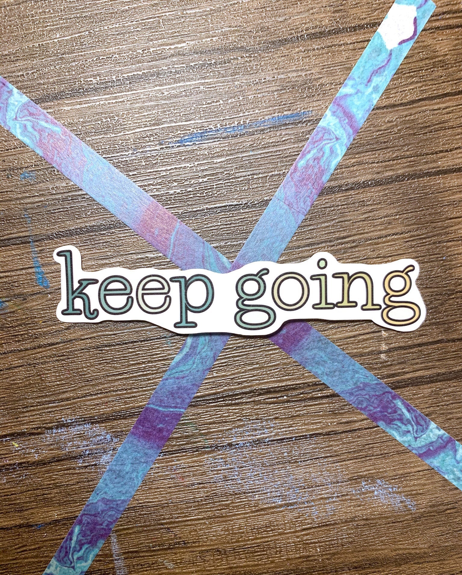 A cute aesthetic Keep Going sticker featuring a motivational design, perfect for personalizing laptops and water bottles.