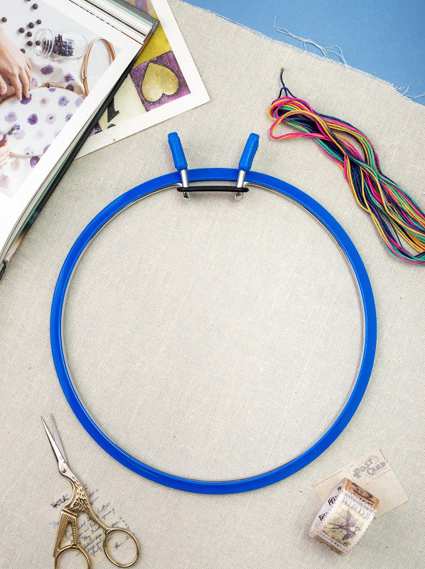 Nurge Large Spring Metal Embroidery Hoop in deep blue, showcasing its two-part design with a plastic ring and flexible metal ring.