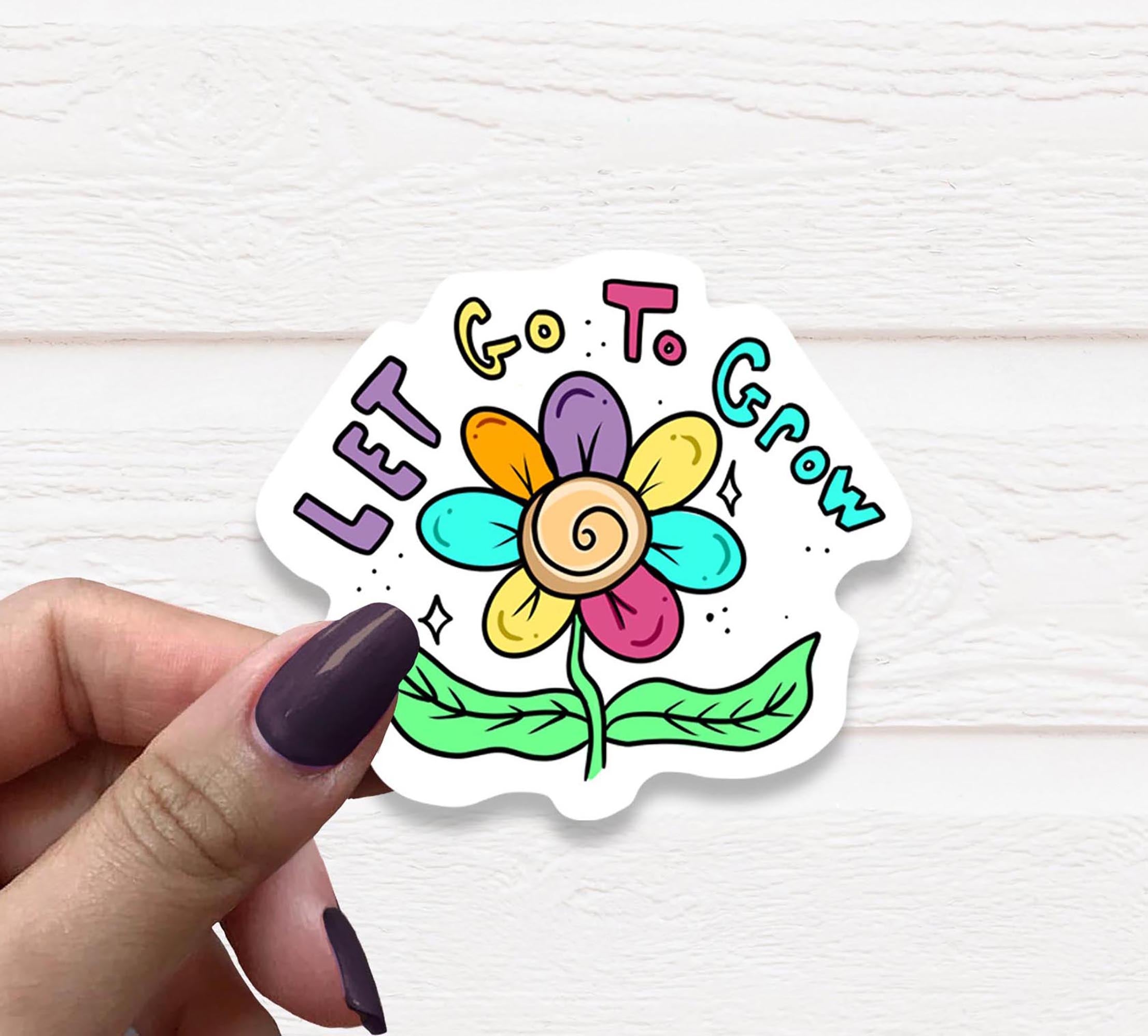 Let Go to Grow Vinyl Sticker on a white background, showcasing its matte finish and vibrant design.