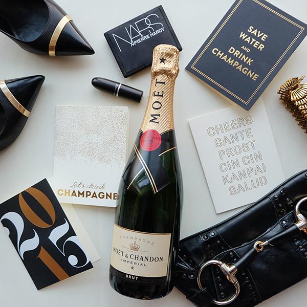 A stylish 'Let's Drink Champagne' greeting card featuring gold foil accents, folded design, and a lined envelope, perfect for various celebrations.