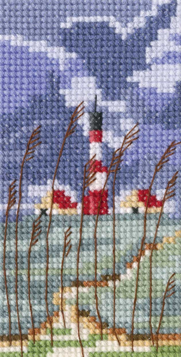 Lighthouse EH355 Counted Cross Stitch Kit with Aida fabric, DMC threads, and instructions displayed on a table.