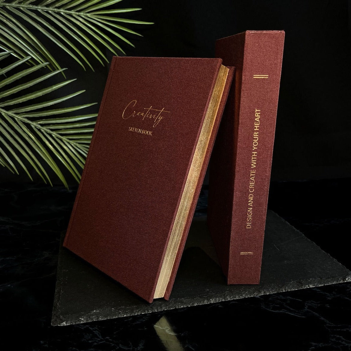 Luxury linen sketchbook with thick paper and gold edging, featuring a silk ribbon bookmark and protective hardback sleeve.