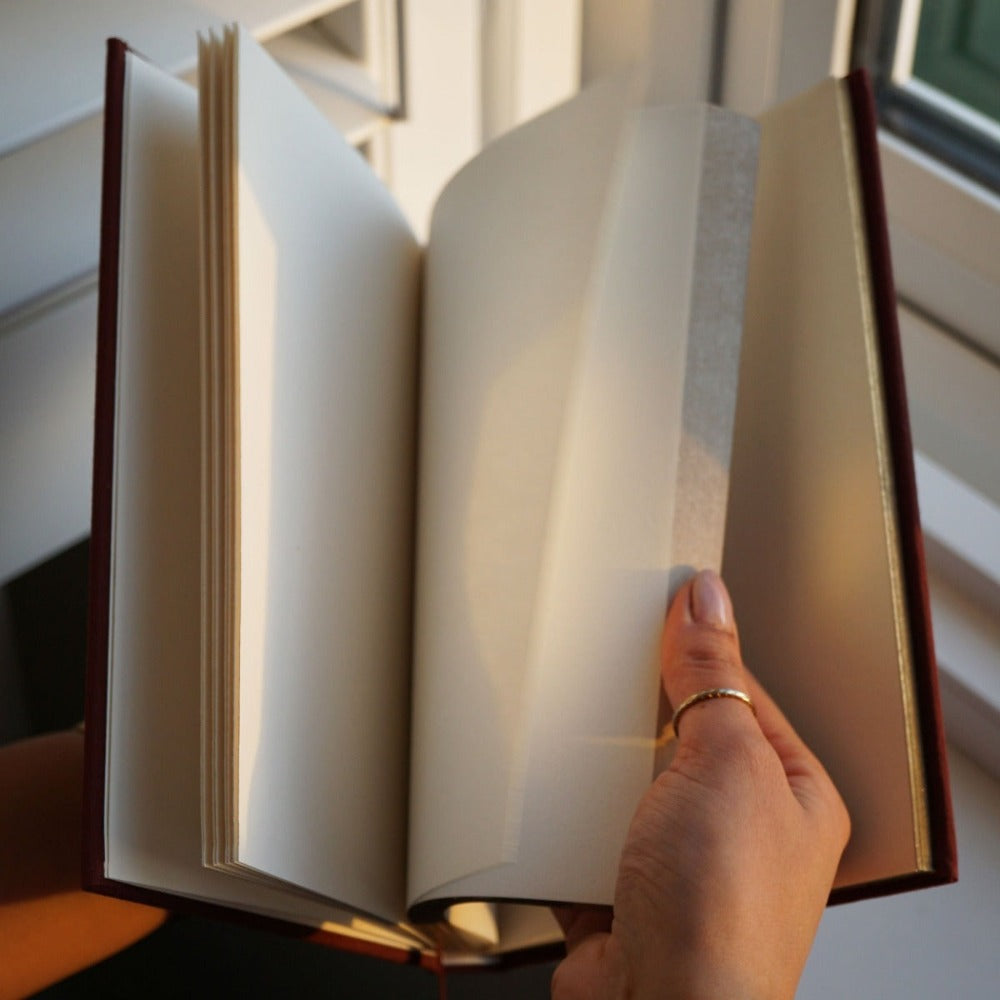 Luxury linen sketchbook with thick paper and gold edging, featuring a silk ribbon bookmark and protective hardback sleeve.