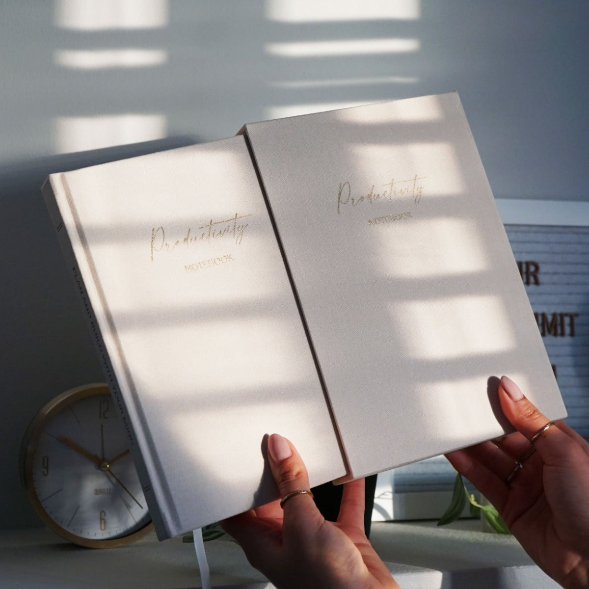 Linen Productivity Lined Notebook with gold edging and silk ribbon bookmark, displayed in a protective hardback sleeve.