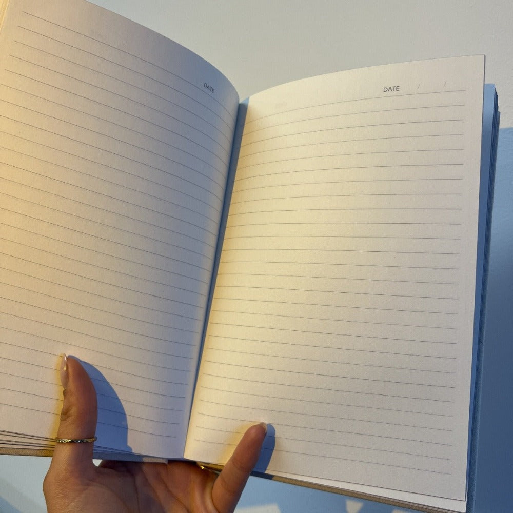 Linen Productivity Lined Notebook with gold edging and silk ribbon bookmark, displayed in a protective hardback sleeve.