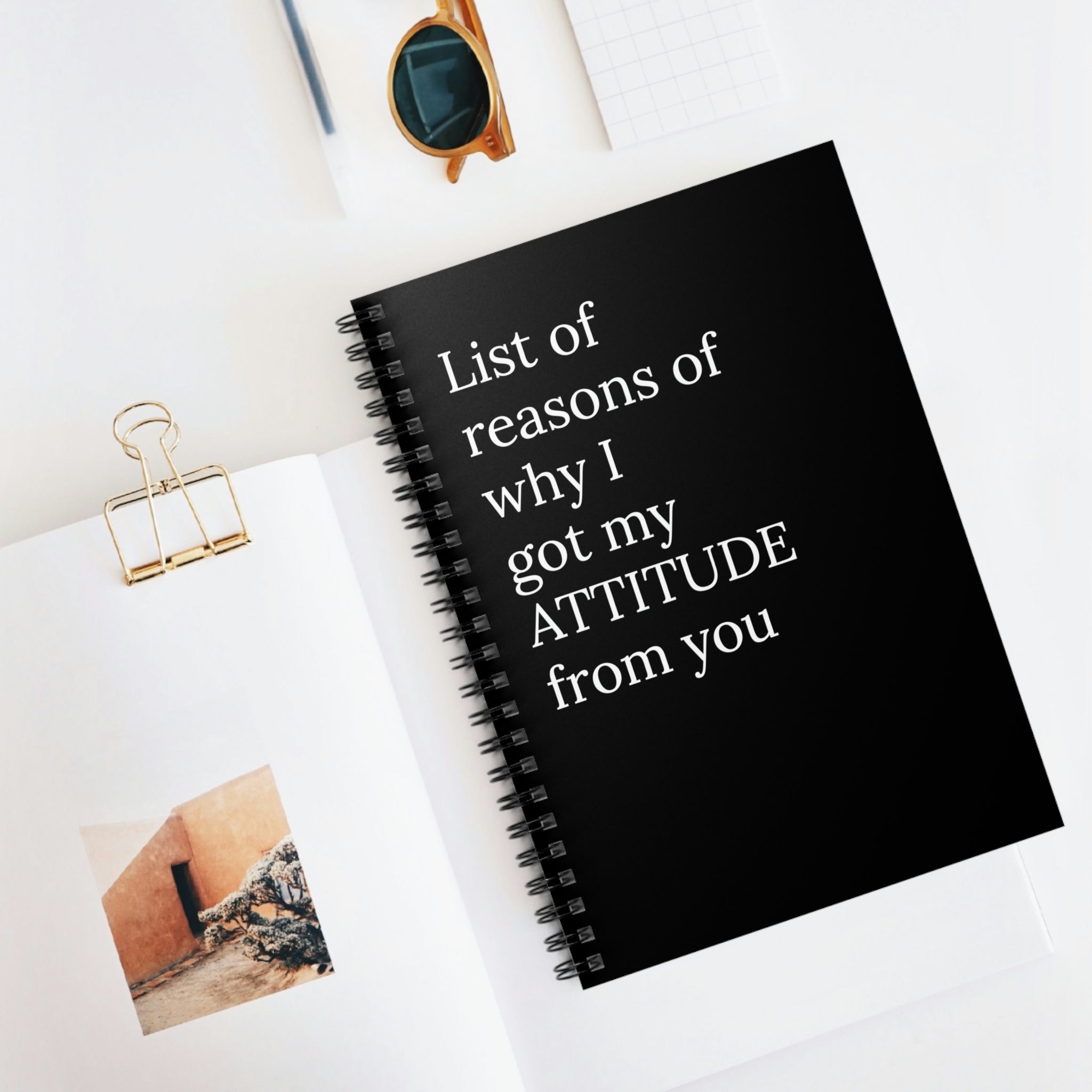 A humorous spiral notebook titled 'List of Reasons Of Why I Got My Attitude From You' featuring a printed cover and ruled line pages.