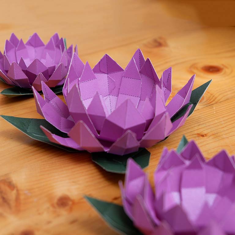 Lotus Paper Craft Flower - Low Poly kit showcasing pre-cut and pre-folded pieces in vibrant colors, perfect for crafting enthusiasts.