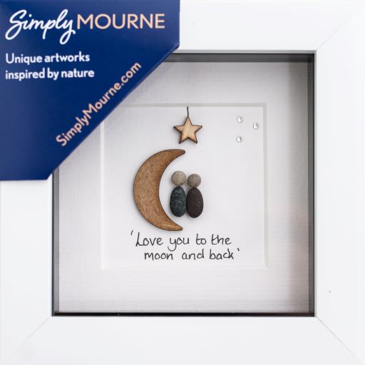 A beautifully framed pebble art piece featuring the phrase 'Love you to the moon and back', showcasing pebbles arranged in a heart shape.