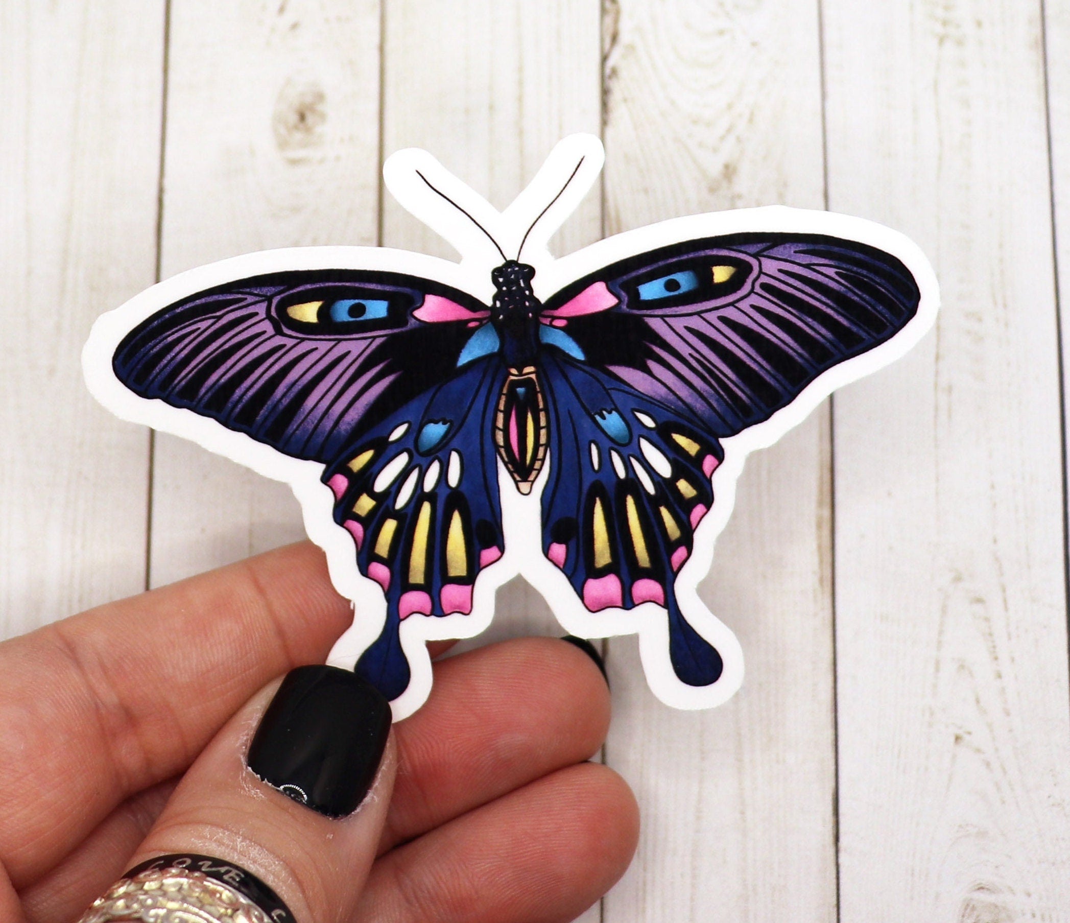 A beautifully designed Lunar Moth Sticker on a matte vinyl surface, showcasing intricate details and vibrant colors.