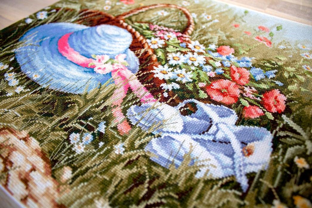 Meadow with Poppies BU4020L Counted Cross-Stitch Kit featuring vibrant flowers and blue hat on high-quality canvas.