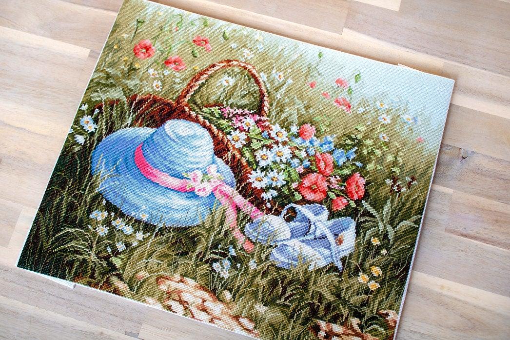 Meadow with Poppies BU4020L Counted Cross-Stitch Kit featuring vibrant flowers and blue hat on high-quality canvas.