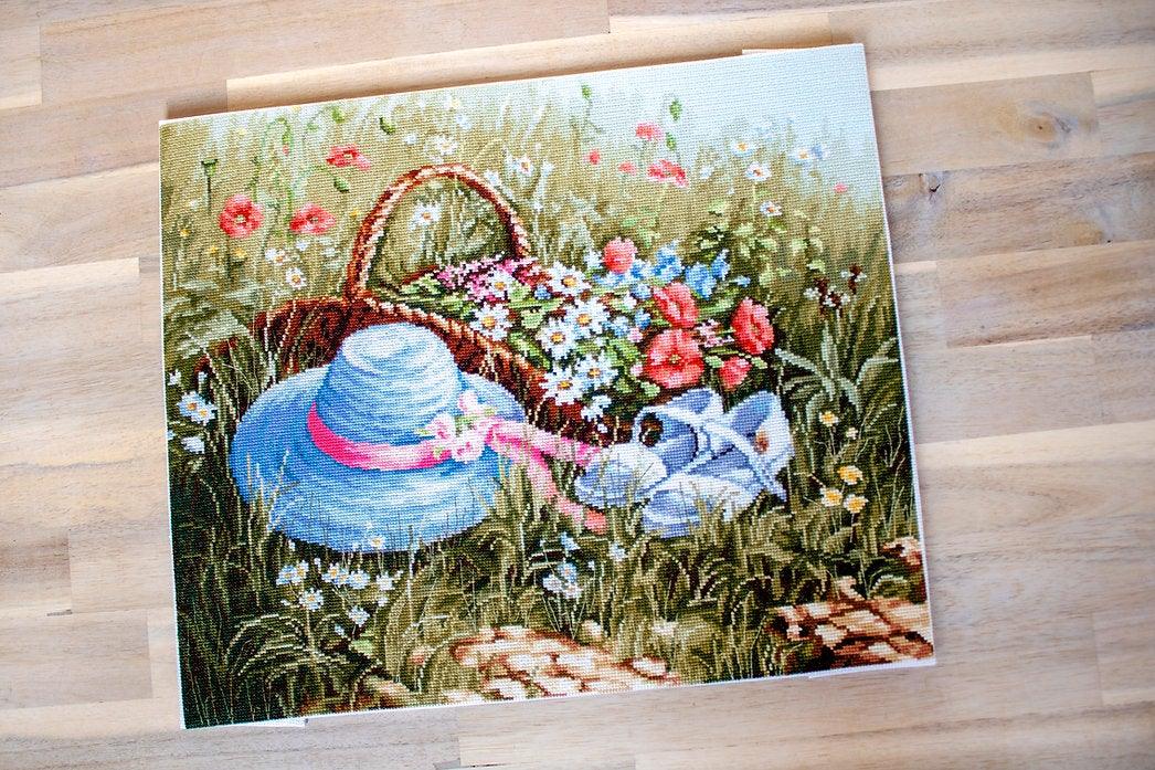 Meadow with Poppies BU4020L Counted Cross-Stitch Kit featuring vibrant flowers and blue hat on high-quality canvas.