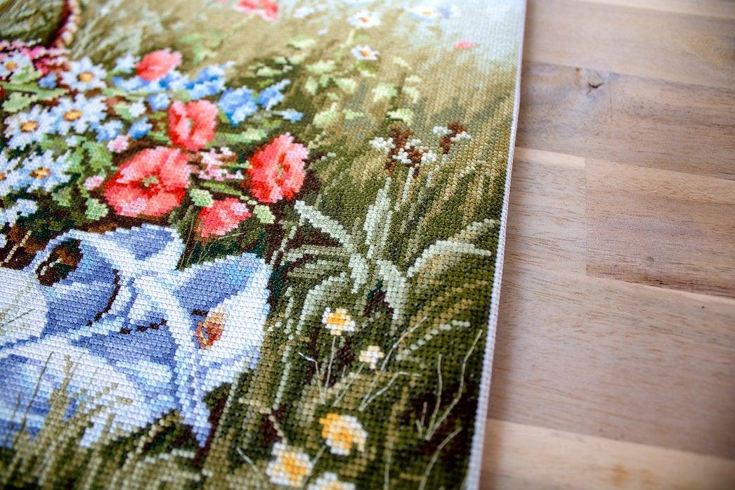 Meadow with Poppies BU4020L Counted Cross-Stitch Kit featuring vibrant flowers and blue hat on high-quality canvas.