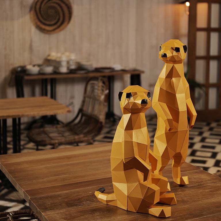 Two charming 3D paper meerkat models, one standing and one seated, showcasing intricate details and vibrant colors.