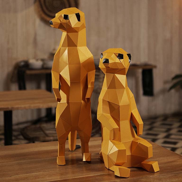 Two charming 3D paper meerkat models, one standing and one seated, showcasing intricate details and vibrant colors.