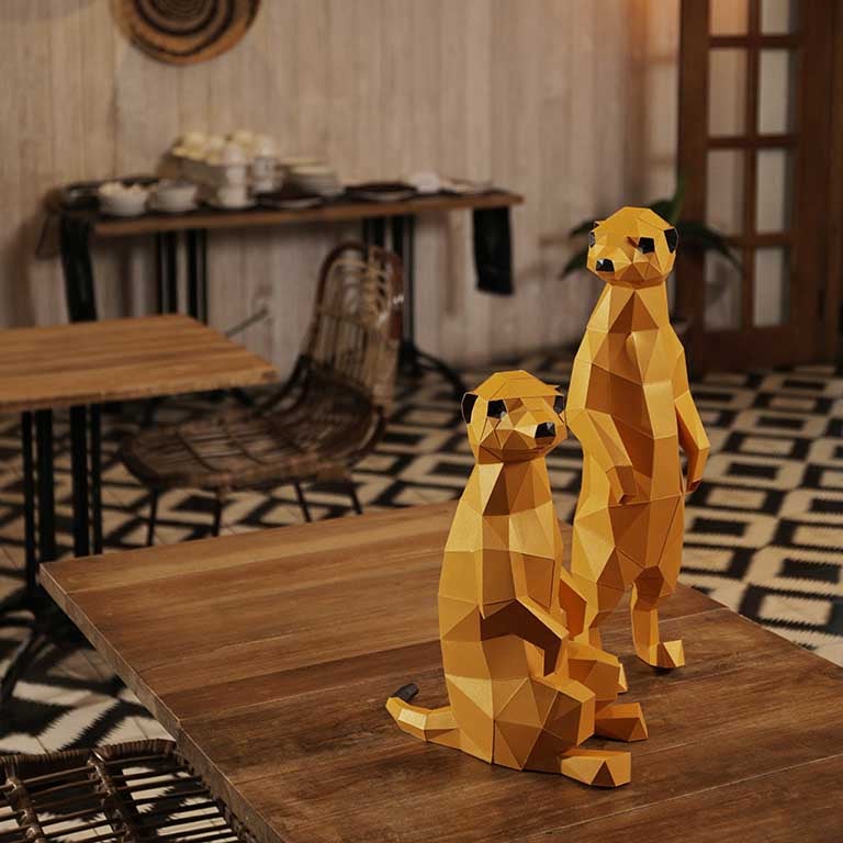 Two charming 3D paper meerkat models, one standing and one seated, showcasing intricate details and vibrant colors.