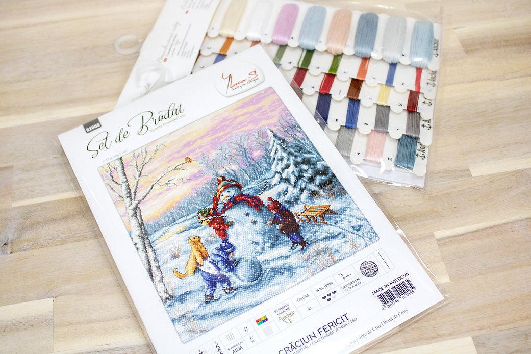 Merry Christmas B2358L Counted Cross-Stitch Kit featuring Aida canvas, colorful threads, and needle for festive crafting.