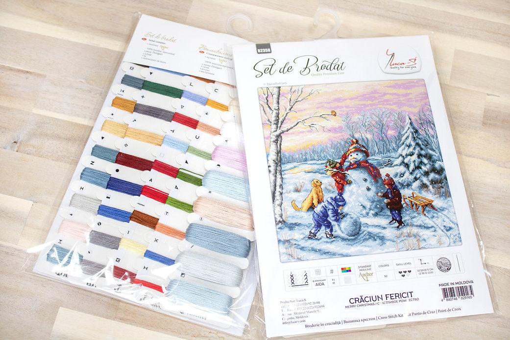 Merry Christmas B2358L Counted Cross-Stitch Kit featuring Aida canvas, colorful threads, and needle for festive crafting.