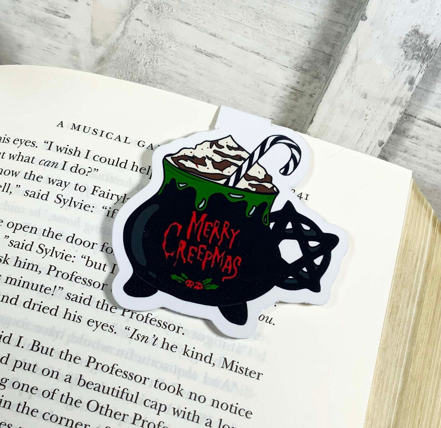 Merry Creepmas Coffee Mug Bookmark featuring a festive design, double-sided, with strong magnets and laminated for durability.