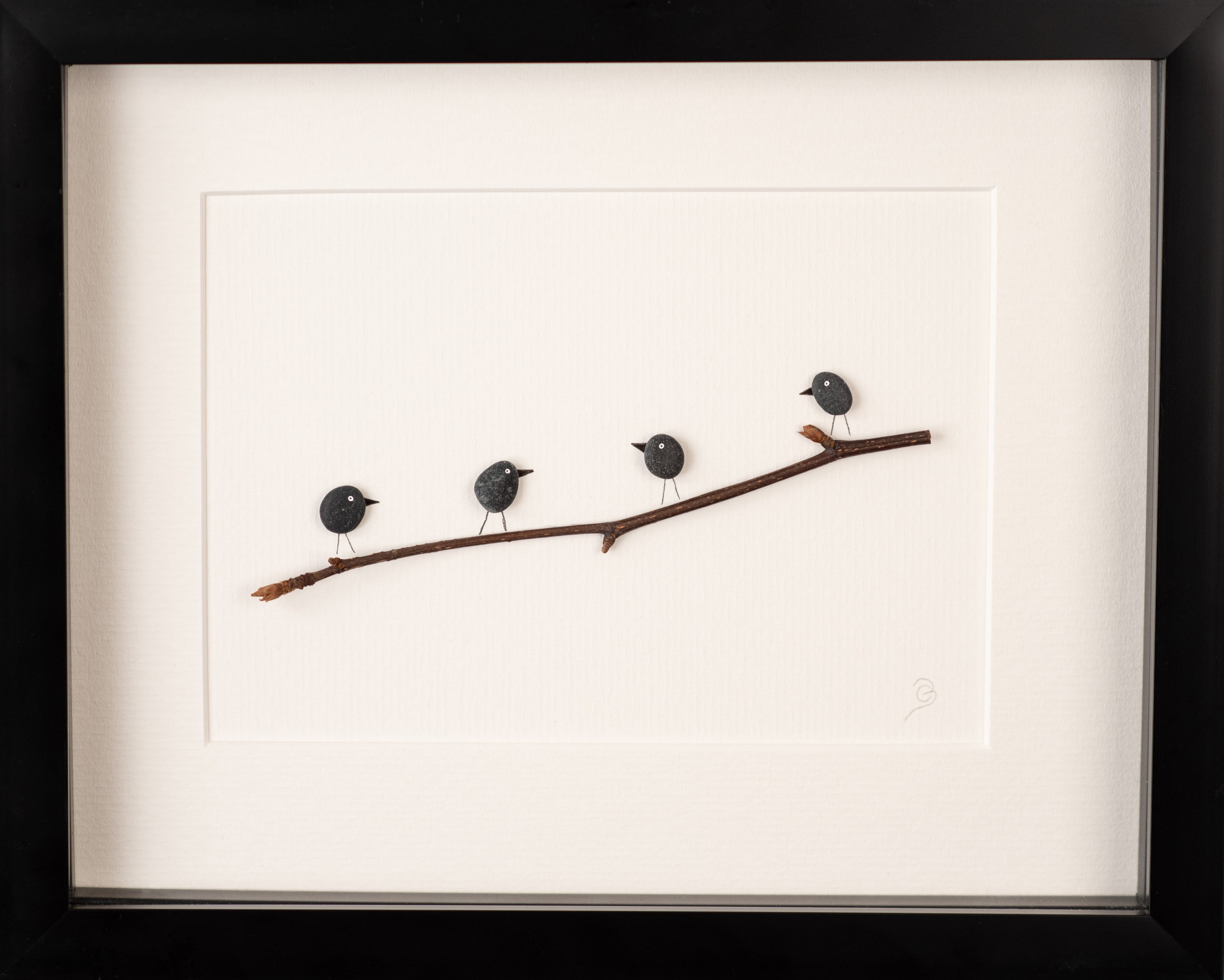 A collection of Mini Birds art pieces framed in white and black, showcasing vibrant colors and unique designs inspired by nature.