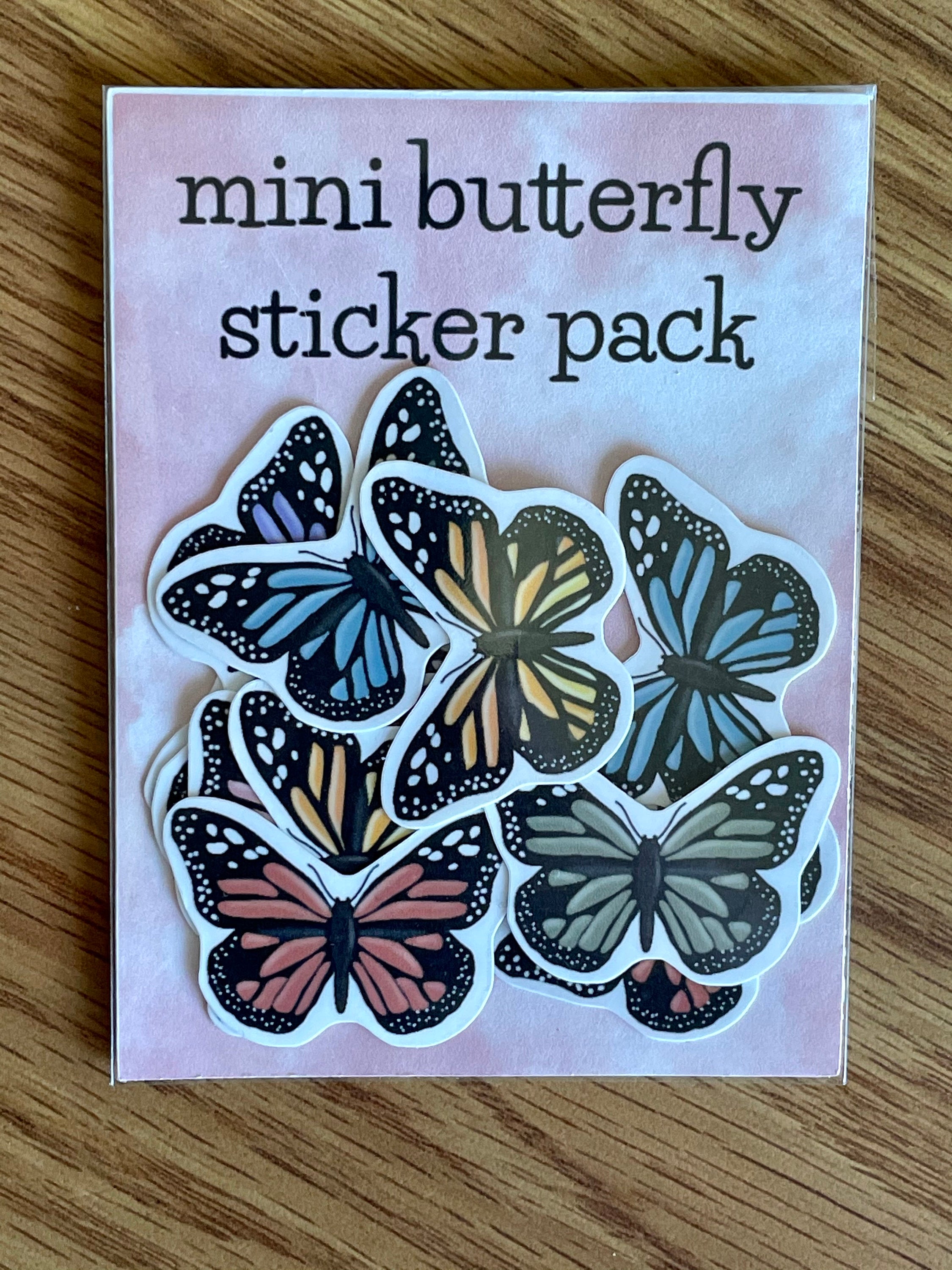 A colorful assortment of 12 mini butterfly stickers, showcasing vibrant designs perfect for personalizing items.