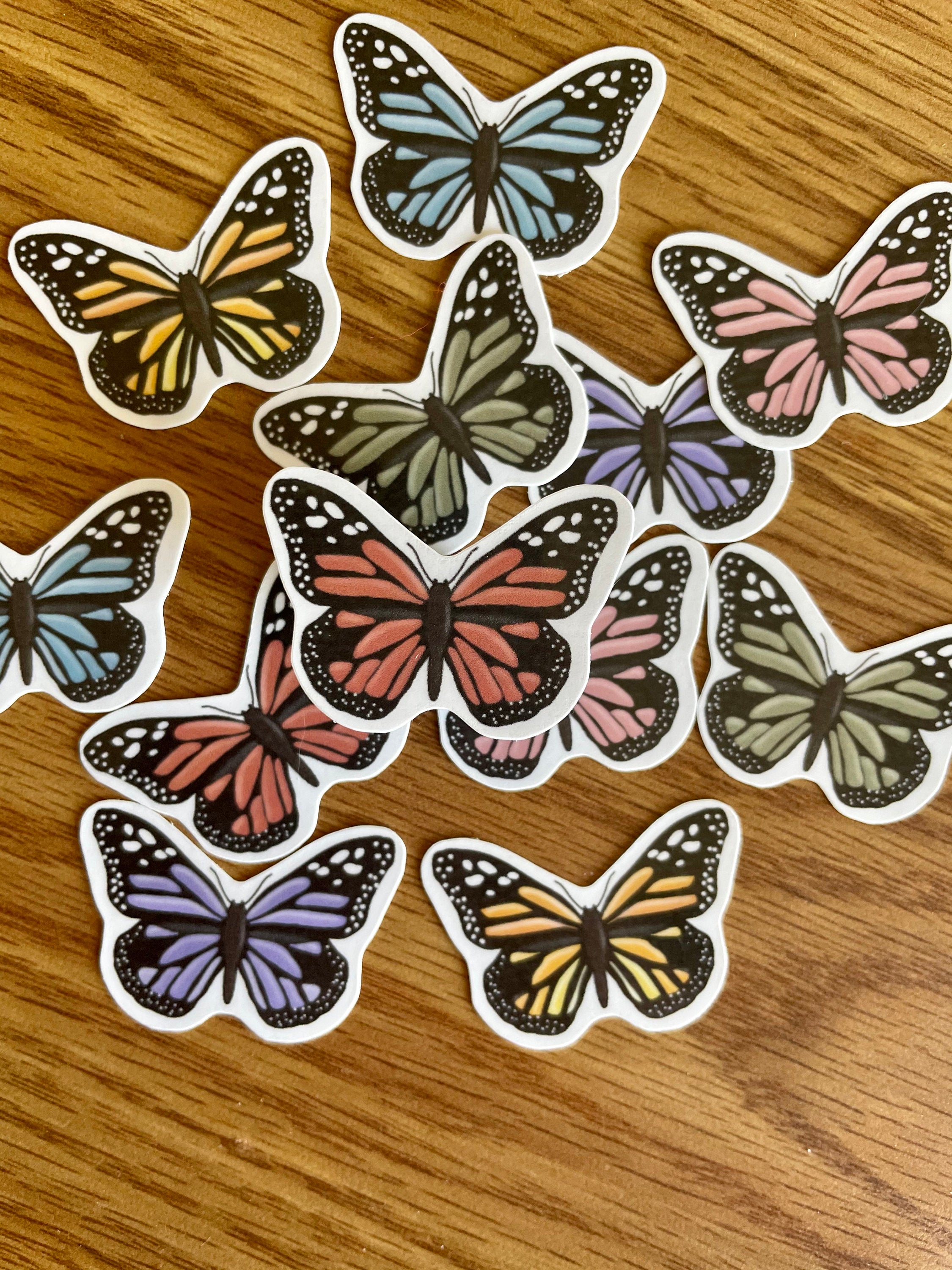 A colorful assortment of 12 mini butterfly stickers, showcasing vibrant designs perfect for personalizing items.