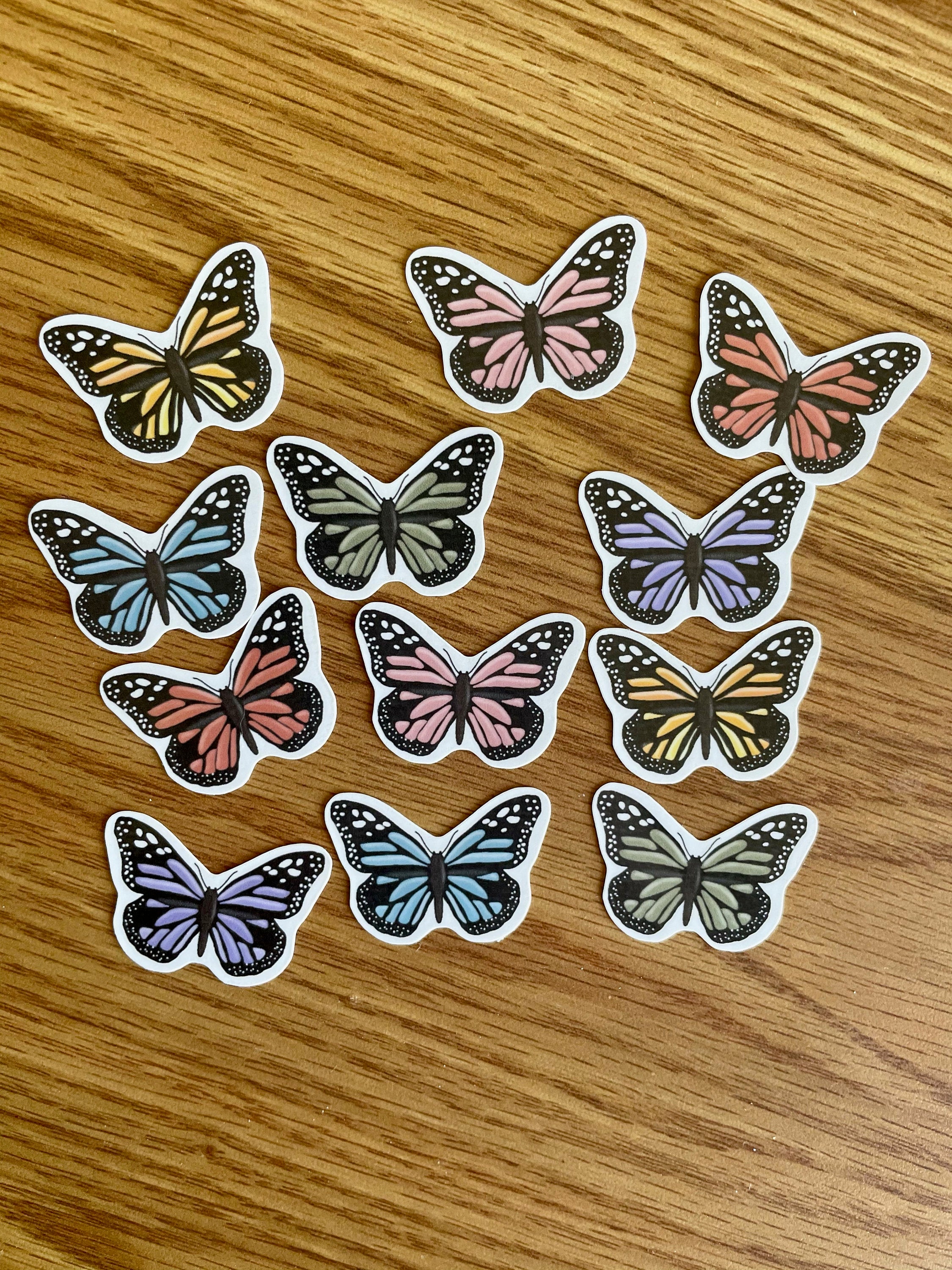 A colorful assortment of 12 mini butterfly stickers, showcasing vibrant designs perfect for personalizing items.