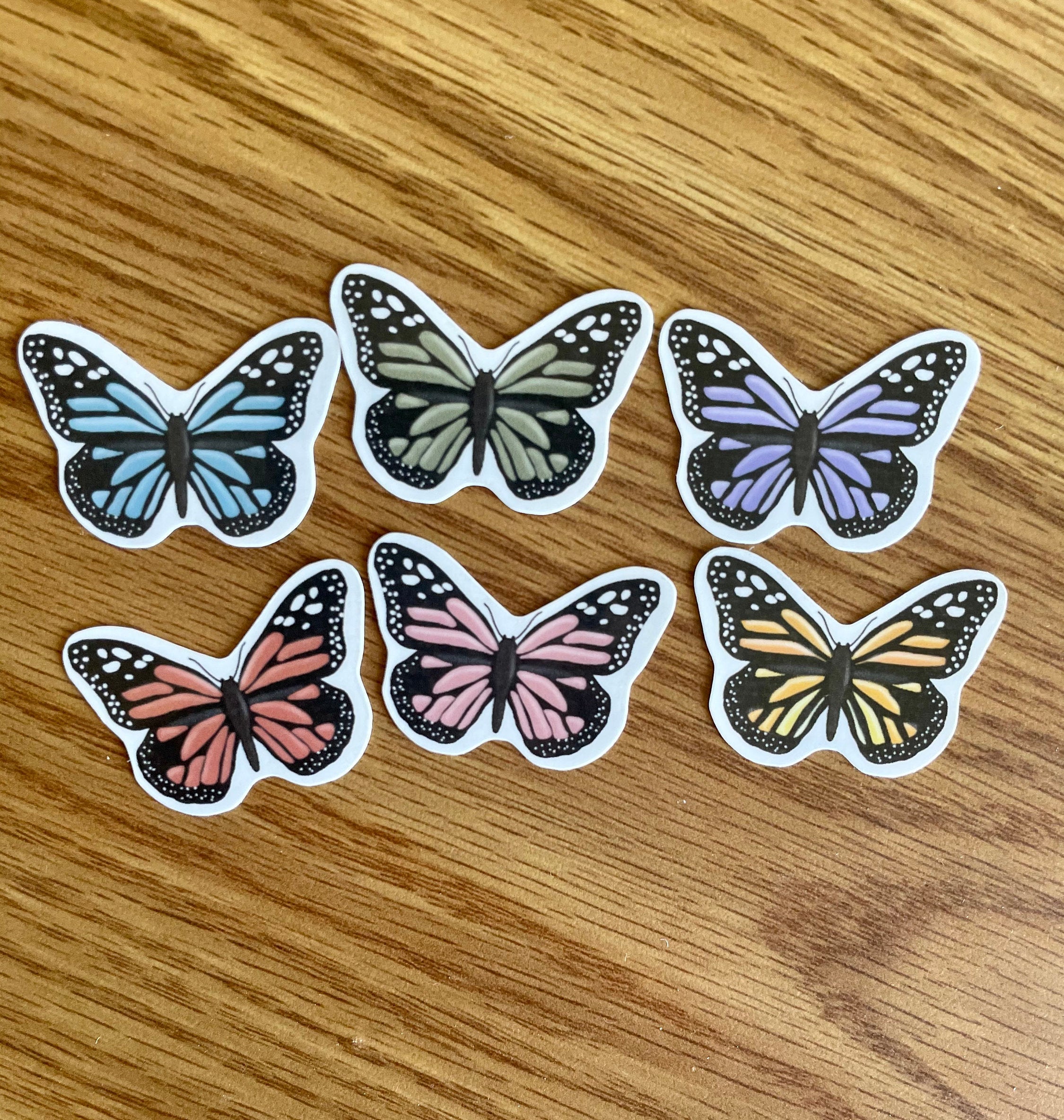 A colorful assortment of 12 mini butterfly stickers, showcasing vibrant designs perfect for personalizing items.