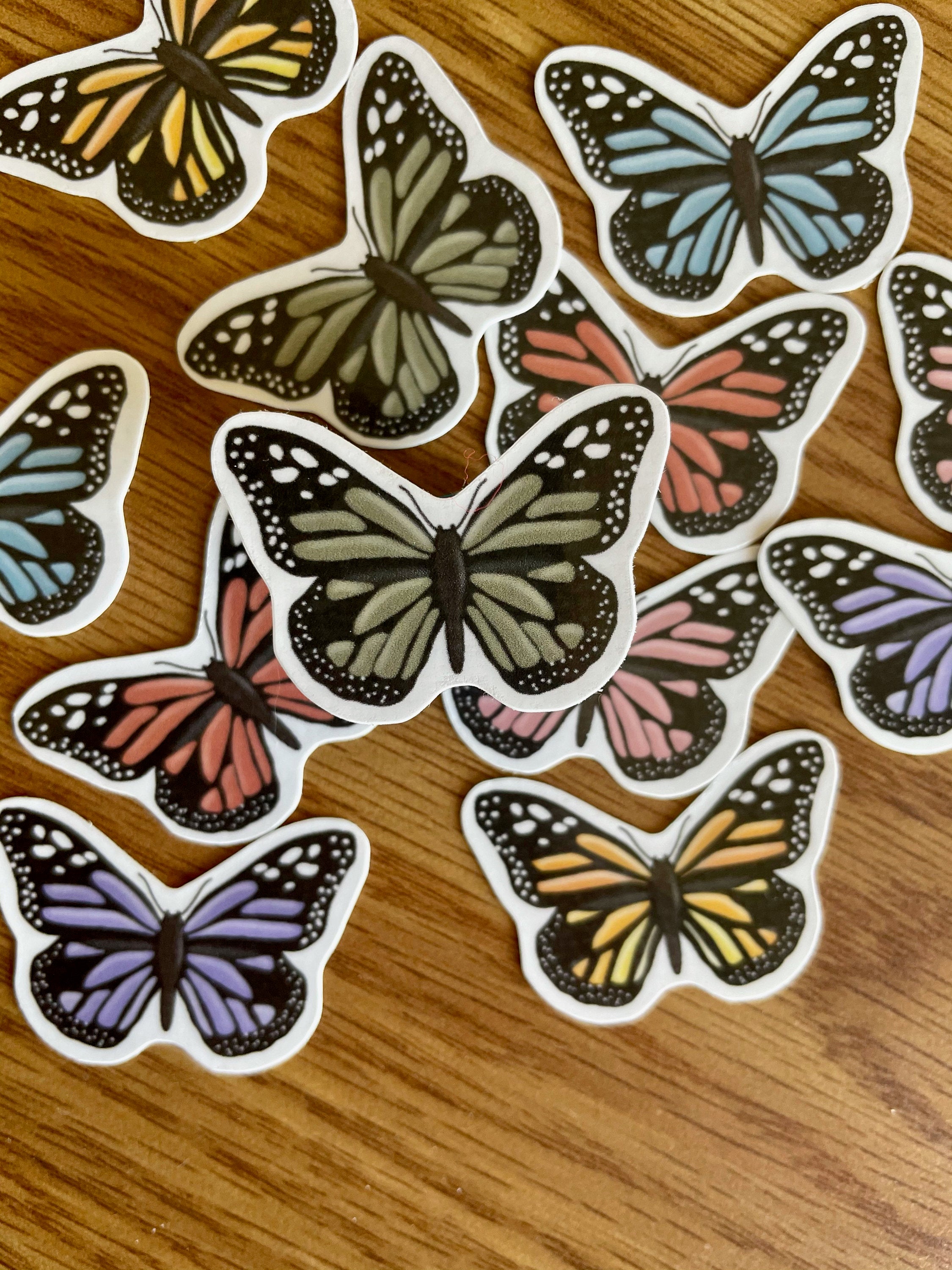 A colorful assortment of 12 mini butterfly stickers, showcasing vibrant designs perfect for personalizing items.