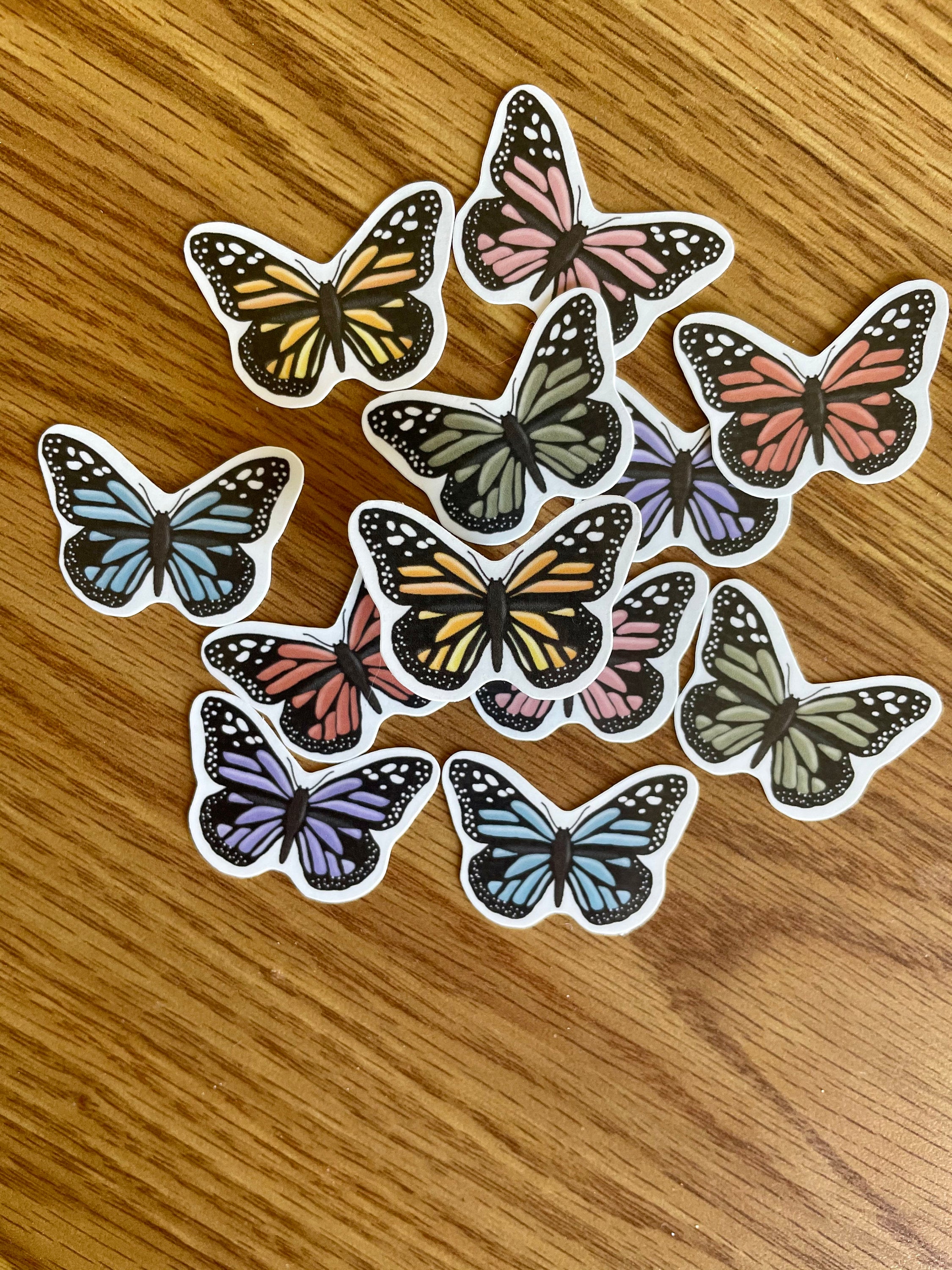 A colorful assortment of 12 mini butterfly stickers, showcasing vibrant designs perfect for personalizing items.