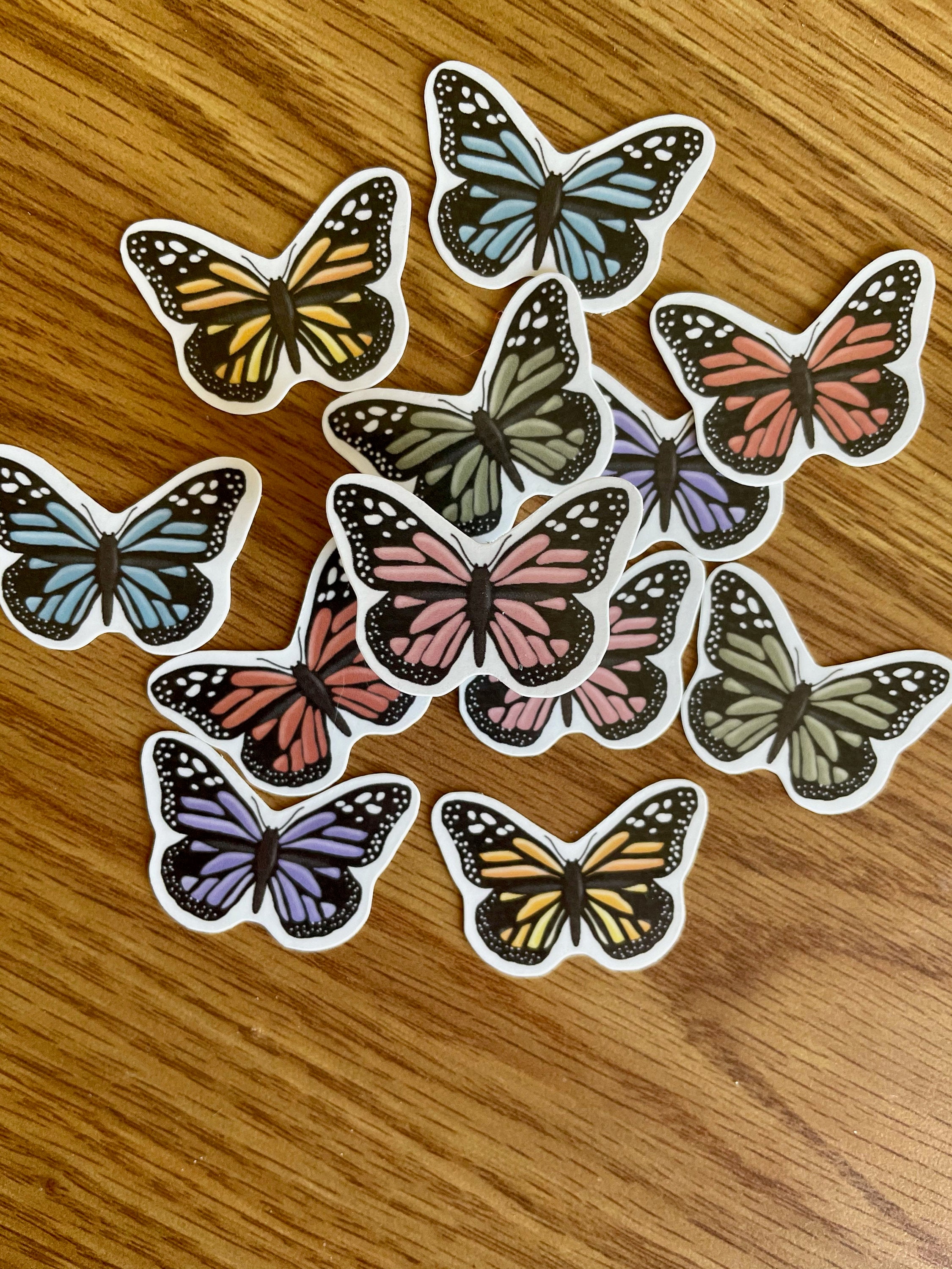 A colorful assortment of 12 mini butterfly stickers, showcasing vibrant designs perfect for personalizing items.